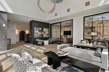 A modern living room with a grey sofa and a black coffee table.